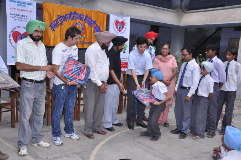 School support activity delivering school bags to children in India